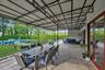 Covered Porch. Fenced backyard featuring outdoor dining area, outdoor lounge area, and a patio
