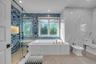 Primary Spa Bathroom with a bidet, a bath, a marble finish shower, marble finish floors, and recessed lighting
