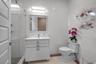 Bathroom featuring vanity, tile walls, tile patterned flooring, and a shower stall