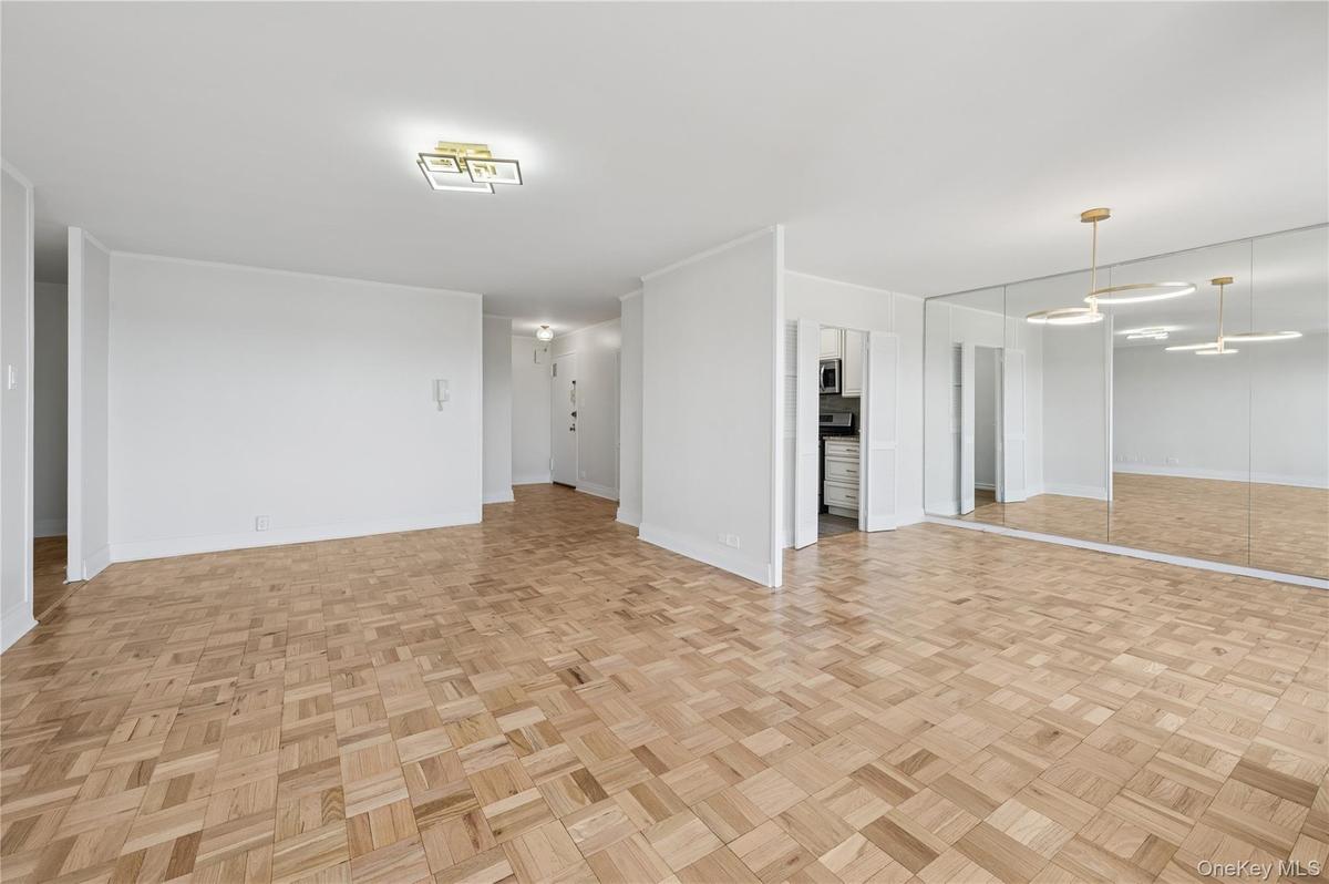 Unfurnished living room featuring baseboards