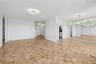 Unfurnished living room featuring baseboards