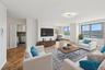 Virtually staged living area with baseboards and ornamental molding