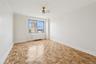 Spare room with radiator and ceiling fan