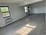 Spare room featuring baseboard heating, wood finished floors, a wall mounted air conditioner, and an AC wall unit