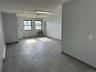 Spare room featuring wood finished floors, an AC wall unit, and a baseboard radiator