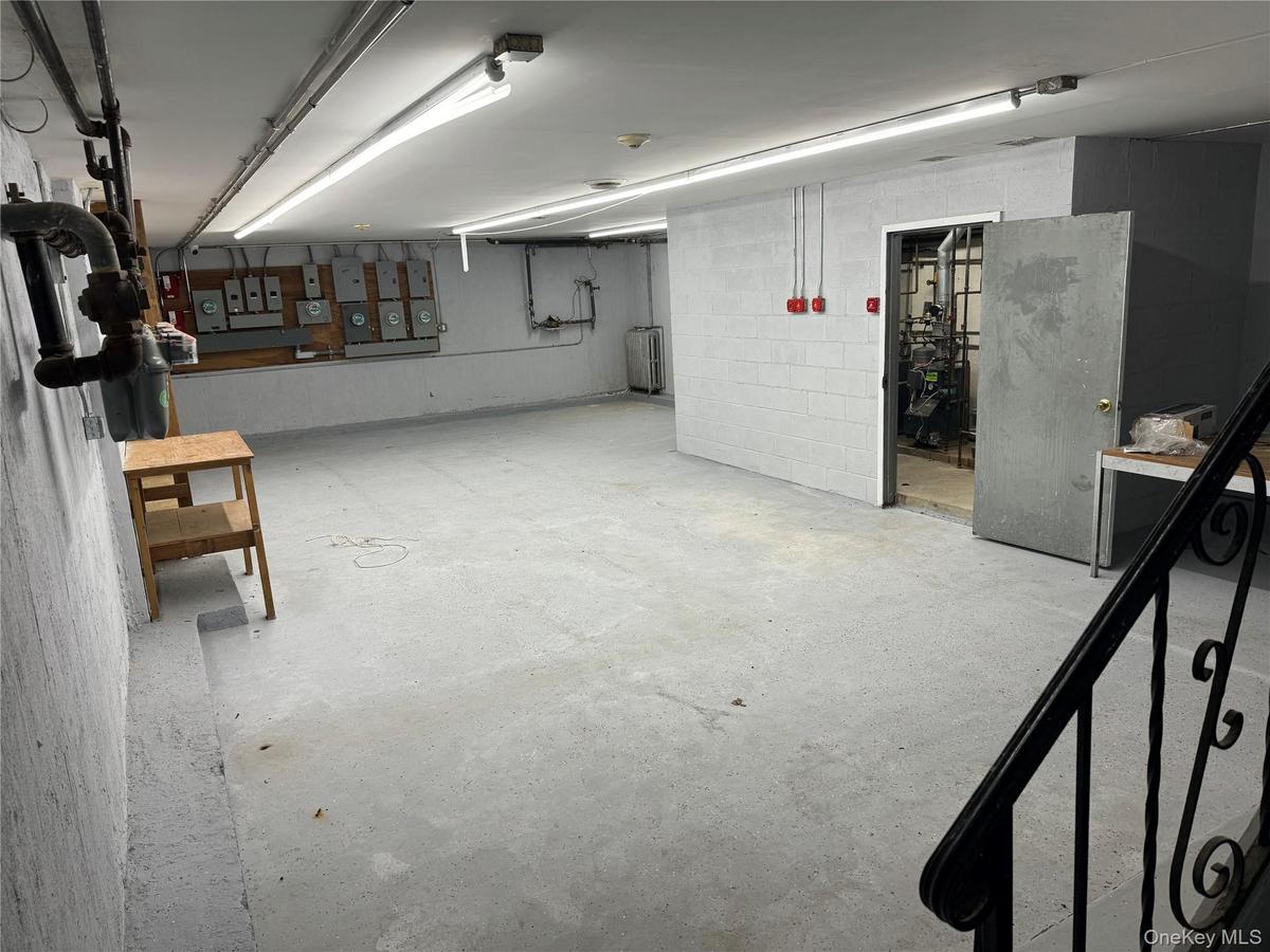 Below grade area featuring concrete block wall and a heating unit