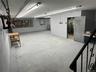 Below grade area featuring concrete block wall and a heating unit