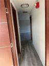 Hallway with light wood-style floors and baseboards