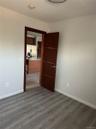 Unfurnished room with dark wood-style flooring and baseboards