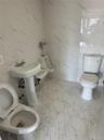 Bathroom featuring tile walls and and toddler toilets