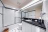Full bathroom with combined bath / shower with glass door, vanity, and light tile patterned floors