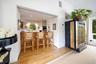 Bar featuring light wood finished floors, recessed lighting, and black oven