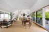 Dining area featuring light wood-style floors and high vaulted ceiling