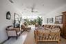 Living area featuring ornamental molding, expansive windows, ceiling fan, and light tile patterned flooring
