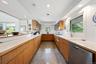 Kitchen featuring recessed lighting, granite floors, dishwasher, glass insert cabinets, and backsplash