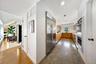 Kitchen with appliances with stainless steel finishes, granite floors, modern cabinets, brown cabinets, and recessed lighting
