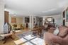 Living area with crown molding and light wood-style flooring