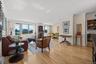 Living room with ornamental molding and light wood-style flooring