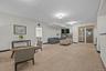 Living room with light colored carpet and baseboards