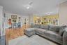 Living area featuring ornamental molding and light wood finished floors