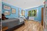 Bedroom with light wood finished floors and baseboards