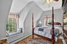 Bedroom #3 featuring a baseboard radiator, ceiling fan, and lofted ceiling