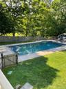 View of open swimming pool featuring a fenced backyard and a patio area