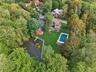 Aerial view of property's location with a pool area and beautiful private pond