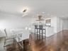 Dining space featuring dark wood-style flooring, ornamental molding, baseboards, and recessed lighting