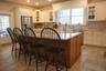 Kitchen featuring sink, a breakfast bar area, a center island with sink, appliances with stainless steel finishes, and white cabinets