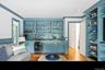 Den and wet bar featuring open shelves