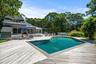 Swimming pool featuring a wooden deck and home