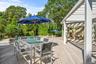 Wooden terrace featuring outdoor dining area and pergola