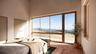 Bedroom featuring wood-type flooring, two closets, and a towering ceiling
