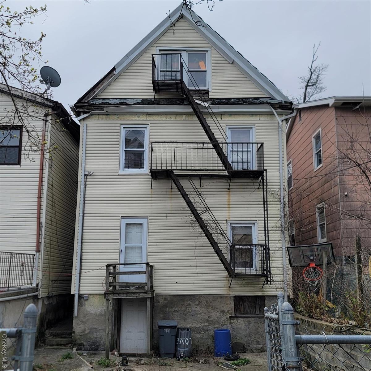 Back of property with a balcony