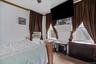 Carpeted bedroom with ceiling fan and cooling unit