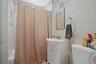 Bathroom featuring tile walls, vanity, and shower / bath combo