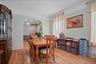 Dining area with a textured ceiling, wood finished floors, and arched walkways