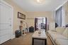 Carpeted living area featuring arched walkways