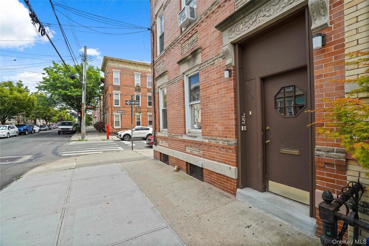 View of exterior entry featuring brick siding