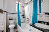 Full bath featuring tile walls, shower / bath combination with curtain, vanity, and tile patterned flooring