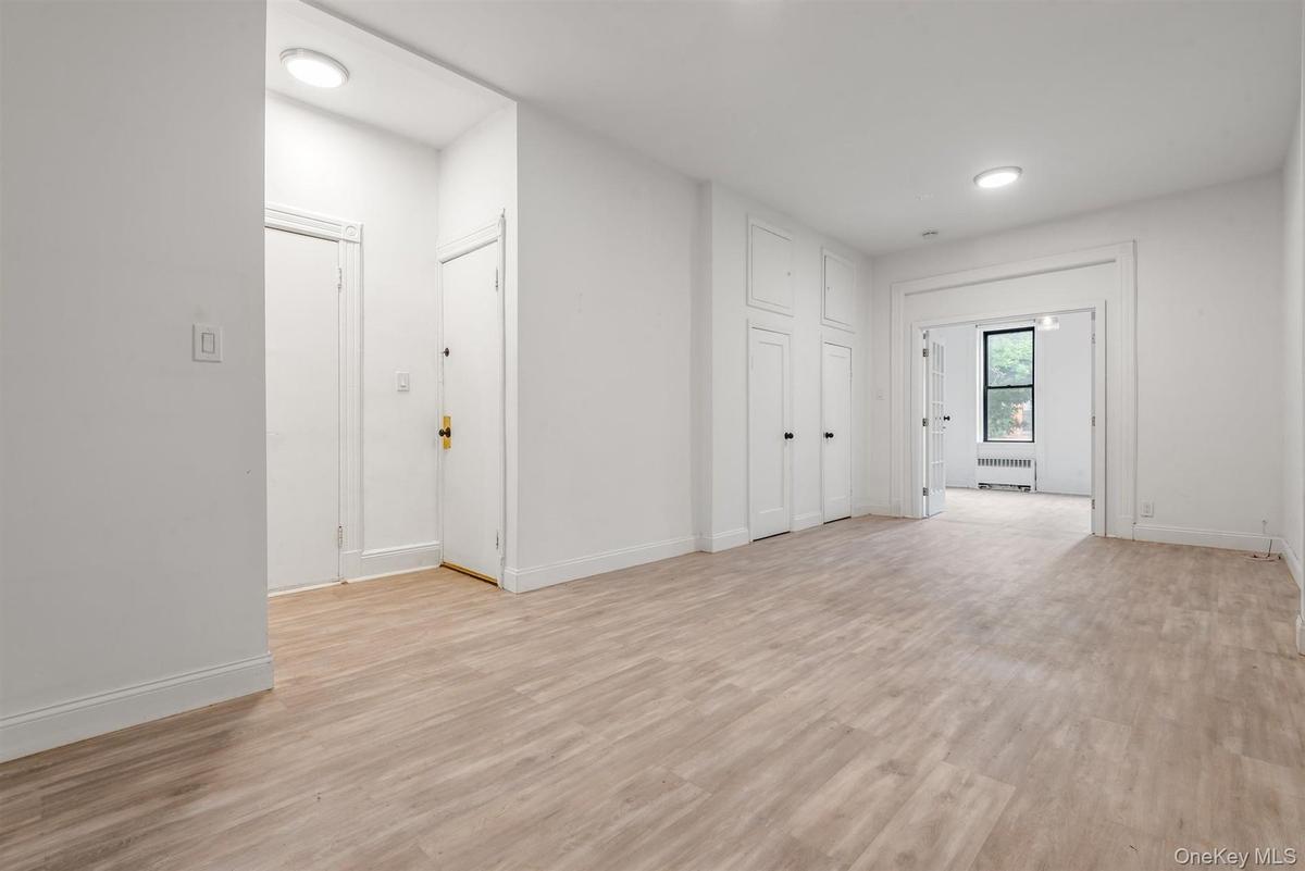Unfurnished room with light wood-type flooring and radiator heating unit