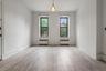 Unfurnished room with ornamental molding, light wood-style floors, and radiator