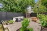 Fenced backyard featuring an outdoor living space, a garden, and a patio area