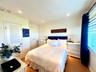 Bedroom featuring light wood-type flooring, a closet, and recessed lighting