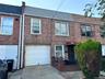 View of front of home - roof, brick siding, driveway, and a garage