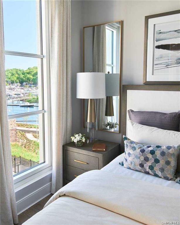 Bedroom featuring a water view and wood finished floors