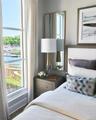 Bedroom featuring a water view and wood finished floors