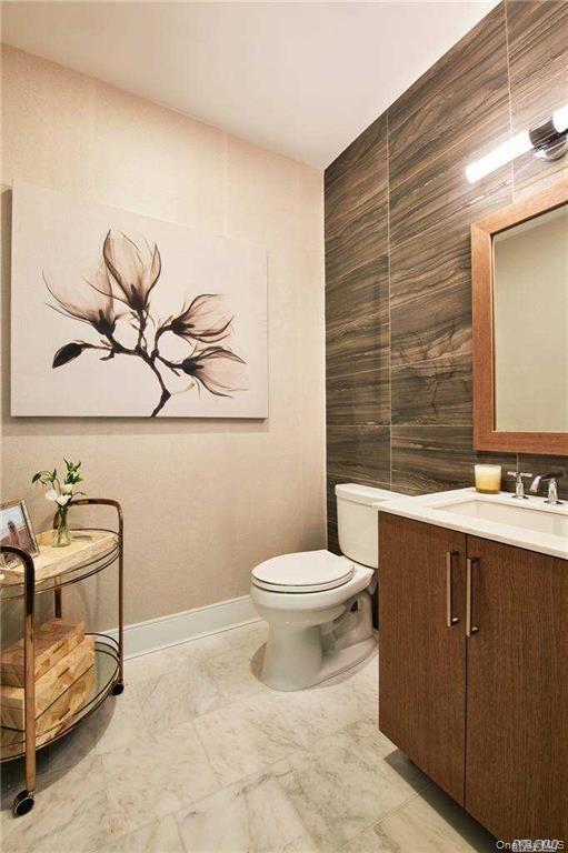 Bathroom featuring vanity and tile walls