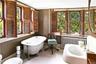 Bathroom with radiator heating unit, a freestanding bath, and wood finished floors